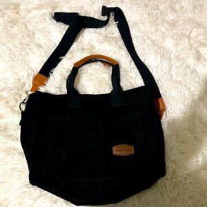 Black tote bag with brown accents.